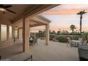 Spacious covered patio with seating area, overlooking a golf course at 13219 W Santa Ynez Dr, Sun City West, AZ 85375