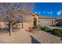 Landscaped front yard with gravel and decorative yard art at 16140 W Almeria Rd, Goodyear, AZ 85395