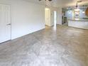 Open concept living area with tile flooring and a view of the kitchen at 16530 N 114Th Dr, Surprise, AZ 85378