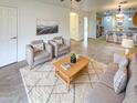 Bright and airy living room with a neutral color palette and comfortable seating at 16530 N 114Th Dr, Surprise, AZ 85378
