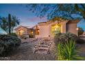 Home with a lighted walkway leading to the front door at 22719 N 93Rd St, Scottsdale, AZ 85255