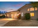 Two-car garage with desert landscaping and a large driveway at 22719 N 93Rd St, Scottsdale, AZ 85255