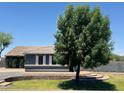 House with a gray exterior, white shutters, and landscaping at 22834 E Mccowan Ct, Queen Creek, AZ 85142