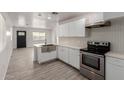 Stylish kitchen boasting stainless steel sink, white cabinets and tile floors at 3212 W Jackson St, Phoenix, AZ 85009