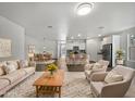 Open living area with beige couch and kitchen views at 41096 W Jenna Ln, Maricopa, AZ 85138
