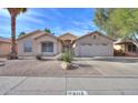 Single-story house with a two-car garage and desert landscaping at 6413 W Irma Ln, Glendale, AZ 85308