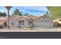 Single-story house with a two-car garage and desert landscaping at 6413 W Irma Ln, Glendale, AZ 85308