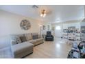 Bright living room featuring a comfortable sectional sofa and easy access to the kitchen at 8323 W Devonshire Ave, Phoenix, AZ 85037