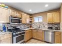 L-shaped kitchen with wood cabinets and granite countertops at 14820 N 35Th St, Phoenix, AZ 85032