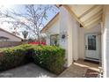 Front entrance with white door and decorative sunburst at 1708 N Parsell Cir, Mesa, AZ 85203