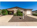 Charming single-story home with a well-maintained front yard and covered parking at 2233 N Middlecoff Dr, Mesa, AZ 85215