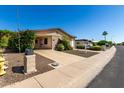Charming single-story home with a well-maintained front yard on a sunny day at 2233 N Middlecoff Dr, Mesa, AZ 85215