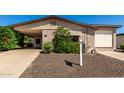 Close-up of a charming single-story home with a well-maintained front yard at 2233 N Middlecoff Dr, Mesa, AZ 85215