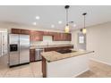 Kitchen features stainless steel appliances, granite countertops, and center island at 2233 N Middlecoff Dr, Mesa, AZ 85215
