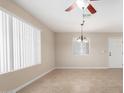 Bright room featuring tile floors, large windows, and a modern chandelier at 2233 N Middlecoff Dr, Mesa, AZ 85215