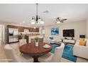 Open-concept living space with dining area, island kitchen, and comfortable seating at 2233 N Middlecoff Dr, Mesa, AZ 85215