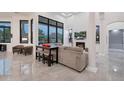 Open living space includes a comfortable seating area, fireplace, and large windows with mountain views at 23807 N 64Th Ave, Glendale, AZ 85310