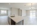 Open concept kitchen with a large island and a seamless flow into the living area at 24177 W Hilton Ave, Buckeye, AZ 85326