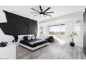 Main bedroom with a dramatic geometric wall and modern decor at 47970 N Navidad Ct, Gold Canyon, AZ 85118
