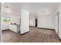 Modern kitchen with white cabinets, a large island, and black countertops at 5823 S 34Th Pl, Phoenix, AZ 85040