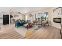 Bright living room with teal sofa and fireplace at 6147 E Lewis Ave, Scottsdale, AZ 85257