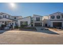 Stylish modern home featuring a two-car garage, contemporary design elements, and easy-care landscaping at 11029 E Ulysses Ave, Mesa, AZ 85212
