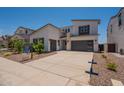 Contemporary home with a concrete driveway, two car garage, and desert landscaping at 11029 E Ulysses Ave, Mesa, AZ 85212
