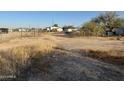 View of unkempt land adjacent to the property at 12629 S Tuthill Rd, Buckeye, AZ 85326