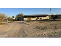 Ranch style home with covered porch and chain link fence at 12629 S Tuthill Rd, Buckeye, AZ 85326