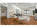 Spacious living area showcasing hardwood floors, a cozy seating arrangement, and large windows at 13454 N 88Th Pl, Scottsdale, AZ 85260