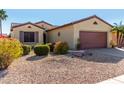 One-story home with a two-car garage and well-maintained landscaping at 15041 W Wrigley Way, Surprise, AZ 85374