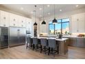 Modern kitchen with white cabinets, large island, and stainless steel appliances at 15214 N Elena Dr, Fountain Hills, AZ 85268