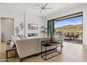 Bright living room featuring a modern fireplace, TV, and sliding doors to the patio at 15214 N Elena Dr, Fountain Hills, AZ 85268
