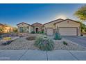 One-story home with stone accents, a three-car garage, and desert landscaping at 18059 W Tierra Del Sol Dr, Surprise, AZ 85387
