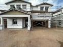 Two-story home exterior under construction with visible framework, scaffolding, and partial roof installation at 22820 E Lords Way, Queen Creek, AZ 85142