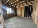 Unfinished interior of room under construction with exposed wooden framing, a window, and concrete flooring at 22820 E Lords Way, Queen Creek, AZ 85142