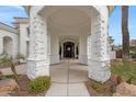 Covered front entrance with stone columns highlighting a walkway leading to the front door at 321 N Portland Ave, Gilbert, AZ 85234