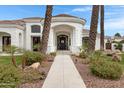 Grand front entrance with decorative landscaping and stone pathway leading to the home's front door at 321 N Portland Ave, Gilbert, AZ 85234