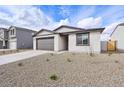 Lovely single-story home showcasing a gravel front yard and an attached two-car garage at 4312 E Bradford Ave, San Tan Valley, AZ 85143