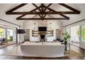 Spacious living room with exposed beams, fireplace, and hardwood floors at 4802 N 46Th St, Phoenix, AZ 85018