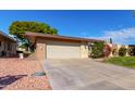 Single story home with attached garage and manicured lawn at 10322 W Manzanita Dr, Sun City, AZ 85373