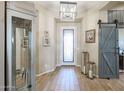Bright and airy entryway with wood-look floors and barn door at 15834 S 177Th Ave, Goodyear, AZ 85338