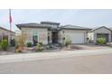 Single story home with a two car garage and desert landscaping at 15834 S 177Th Ave, Goodyear, AZ 85338