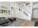 Bright and airy entryway with tile floors and staircase to the second floor at 16142 N 102Nd Way, Scottsdale, AZ 85255