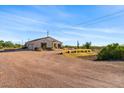 Desert landscape with a single story home and garage at 1623 E Hidalgo St, Apache Junction, AZ 85119