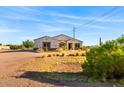 Single-story home with stone accents and desert landscaping at 1623 E Hidalgo St, Apache Junction, AZ 85119