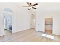 Bright bedroom with wood-look flooring and access to a bathroom at 17124 N Melissa Ln, Surprise, AZ 85374