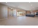 Bright and airy living room featuring tile flooring, ample natural light, and seamless indoor-outdoor flow at 17251 W Montpelier St, Surprise, AZ 85388