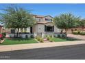 Two-story house with landscaping, driveway, and a metal gate at 17962 W Montecito Ave, Goodyear, AZ 85395