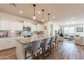 Modern kitchen with granite island and white cabinets at 1806 E Azafran Trl, Queen Creek, AZ 85140